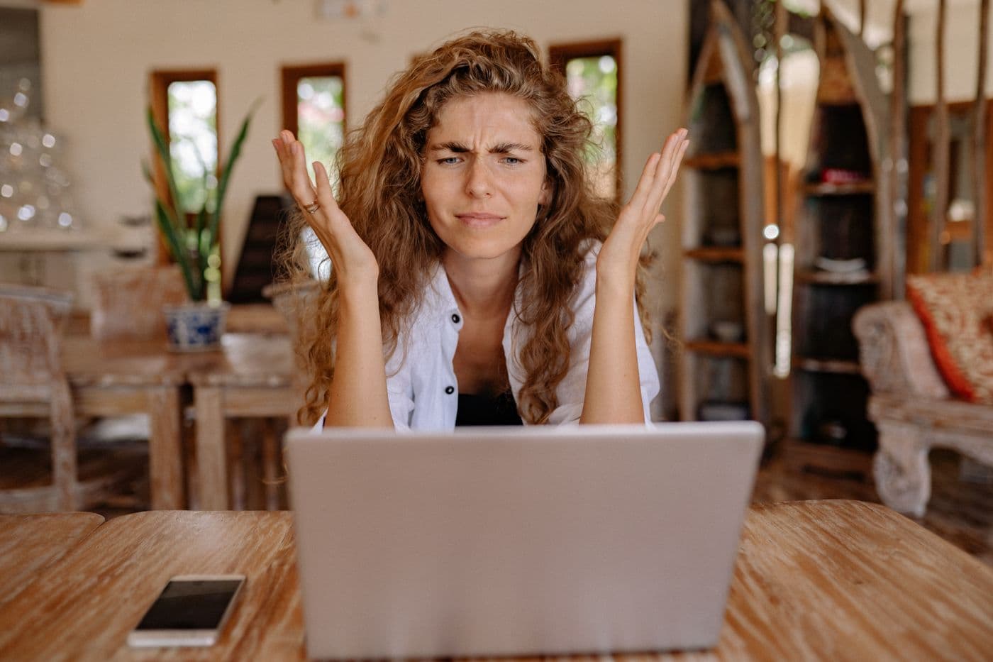 Frustrated job applicant reacting to a rejection on her laptop — the human cost of biased AI screening